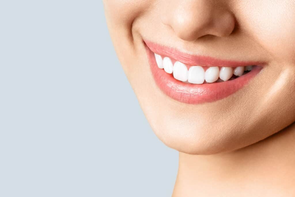 Close-up of smiling mouth with white teeth
